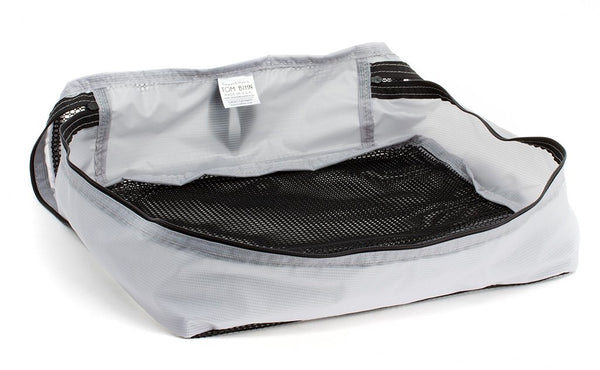 An empty and zipped closed Northwest Sky (light grey) Aether Large Aeronaut 45 Packing Cube.